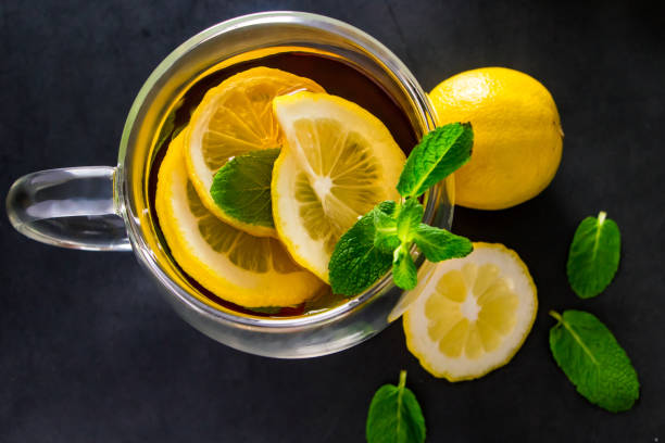 istock Herbal tea with lemon and mint on dark background. Delicious drink for relaxation and refreshment 1343185826