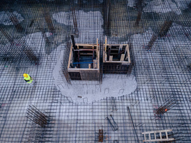 Aerial view of construction site foundations, engineer working. Architect comparing the projects on her tablet with the actual work done on the site. Woman working in the construction industry. reinforced concrete stock pictures, royalty-free photos & images