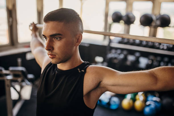istock Man exercising in gym 1343188381