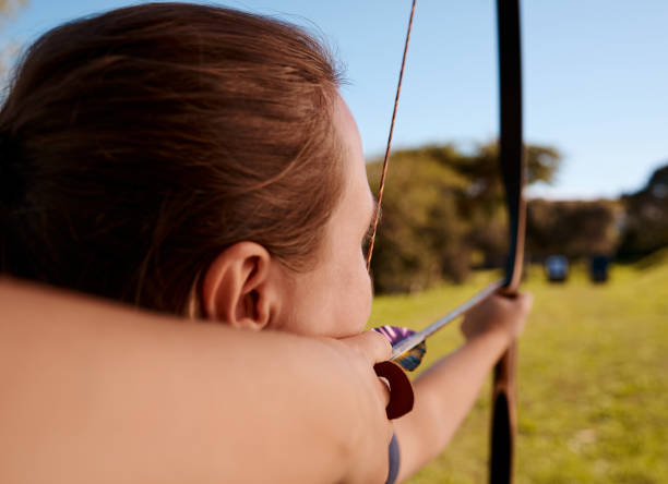 istock Rearview shot of an unrecognizable female archer practicing her craft out on the archery range 1343189019