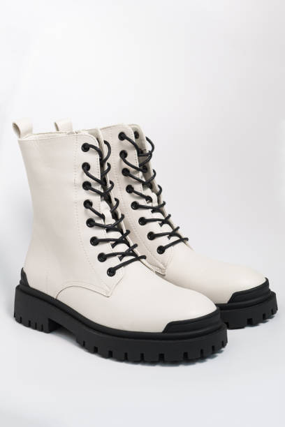 istock White womens autumn rough army boots on a tractor sole with laces, on white background 1343189724