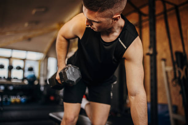 istock Fit man training with dumbbell in gym 1343190124