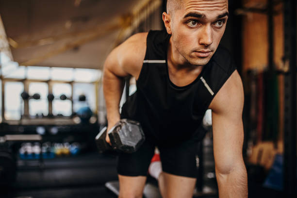 istock Fit man training with dumbbell in gym 1343190227