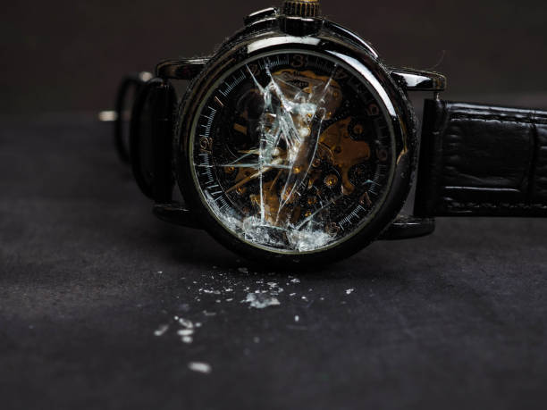 Close up shot of black automatic wristwatch that has a broken glasses. The watch equipped with leather strap