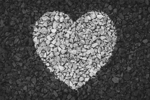 Vector illustration of Black and white coloured pebbles making one big heart painted on gravel road; Valentine's Day or anniversary love greetings related vector backgrounds