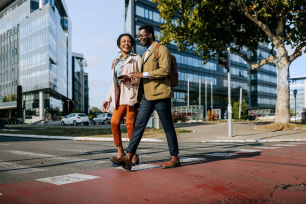istock Two coworkers crossing street 1343193246
