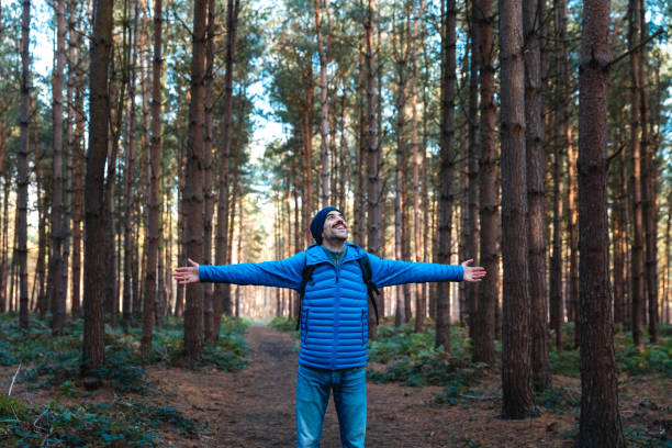 istock Man in the forest hiking and exploring wild remote areas 1343193362
