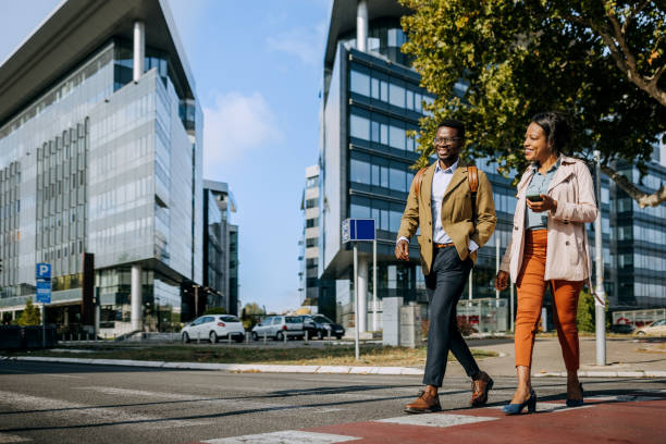 istock Two coworkers crossing street 1343193364