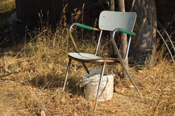 istock A rusty chair and a white plastic bucket abandoned in a field (Umbria, Italy, Europe) 1343193844