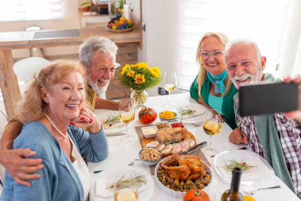 istock Senior friends taking a selfie over Thanksgiving dinner 1343194959