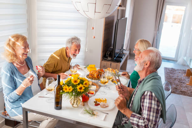 istock Senior friends having Thanksgiving dinner together 1343196103