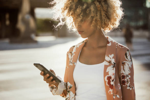 istock Young woman on her phone walking 1343198470