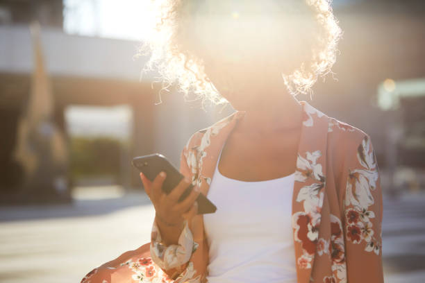 istock Young woman on her phone walking 1343198472