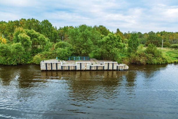 istock Old pier for small boats on the river bank 1343200077