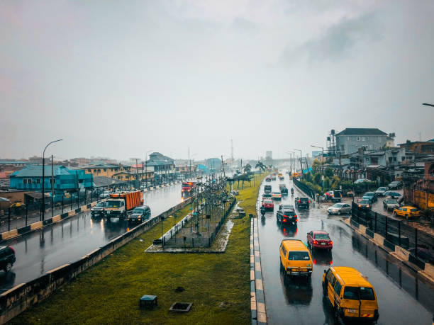 Traffic and cityscape of Lagos during the rain Ogudu, Lagos - Nigeria - September 25, 2021: Traffic and cityscape of Traffic and cityscape of Lagos during the rain lagos nigeria stock pictures, royalty-free photos & images