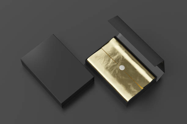istock Black opened and closed rectangle folding gift box mock up with gold wrapping paper on black background. View above. 1343202297
