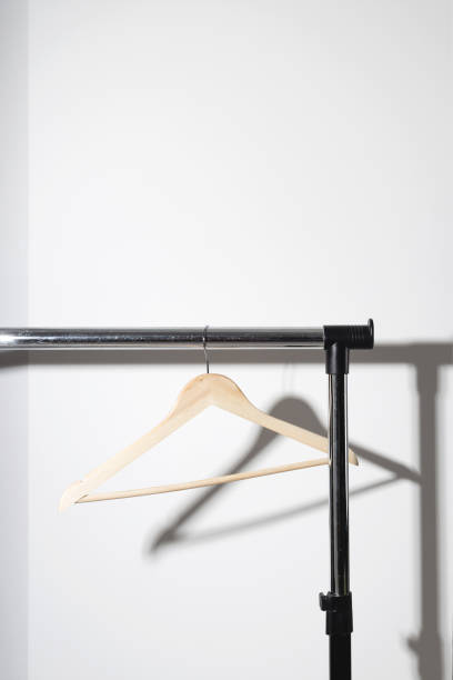 istock Empty single clothes hanger on plain. Conscious consumption slow fashion concept. Minimalist. 1343204705