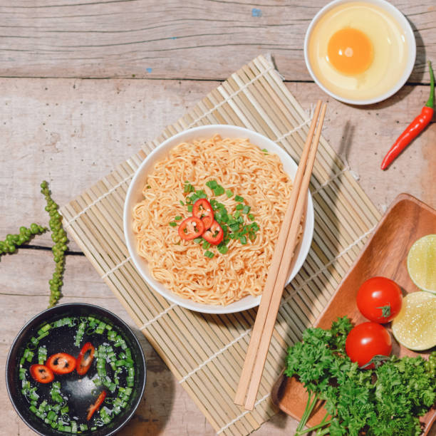 istock noodle in bowl and ingredients on wood background 1343204752