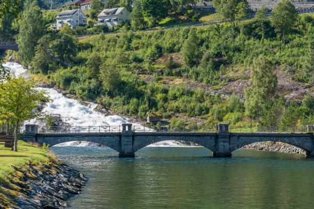 HELLESYLT, NORWAY - 2020 AUGUST 10. Hellesyltfossen waterfall and the beautiful stone bridge.
