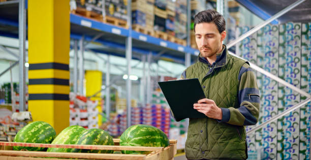 istock Male worker checking watermelon shipment in warehouse 1343209533