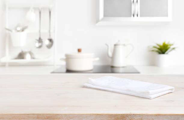 istock White napkin on table with blurred kitchen cooking zone background 1343213716