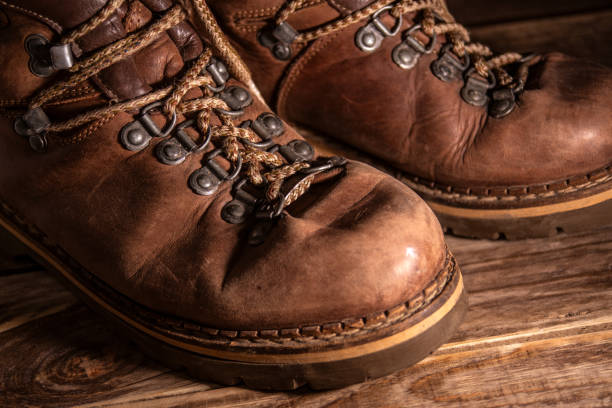 istock Old distressed leather shoes on wooden background 1343214586
