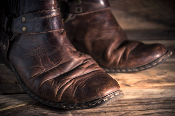 istock Old distressed leather shoes on wooden background 1343214589