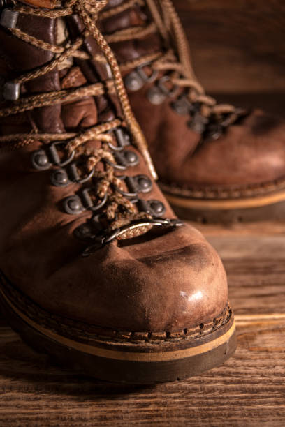 istock Old distressed leather shoes on wooden background 1343214592