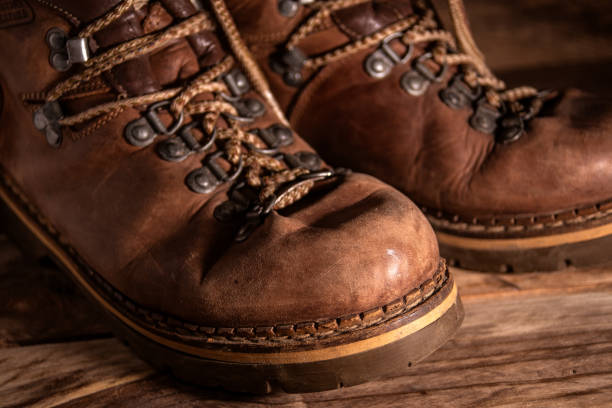 istock Old distressed leather shoes on wooden background 1343214602