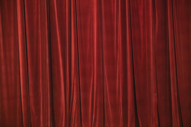 istock Red curtain in theatre. Textured background 1343223336