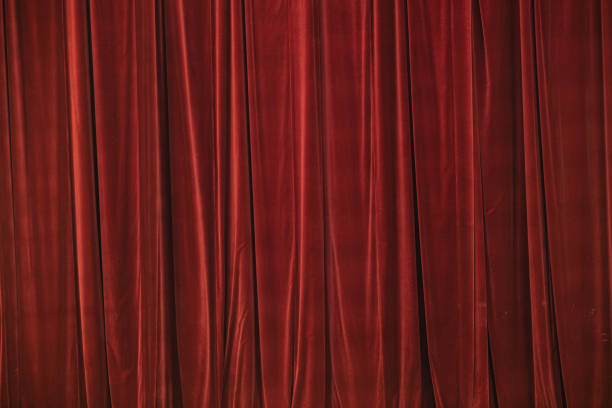istock Red curtain in theatre. Textured background 1343223356