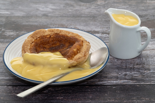 A small Bakewell pudding with custard