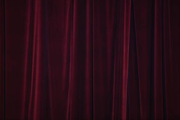 istock Red curtain in theatre. Textured background 1343230312