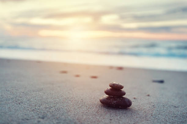 istock Zen stones on calm beach at sunset 1343230422