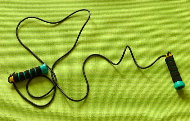 istock Jumping rope on green Trainning mat in heart shape 1343233861