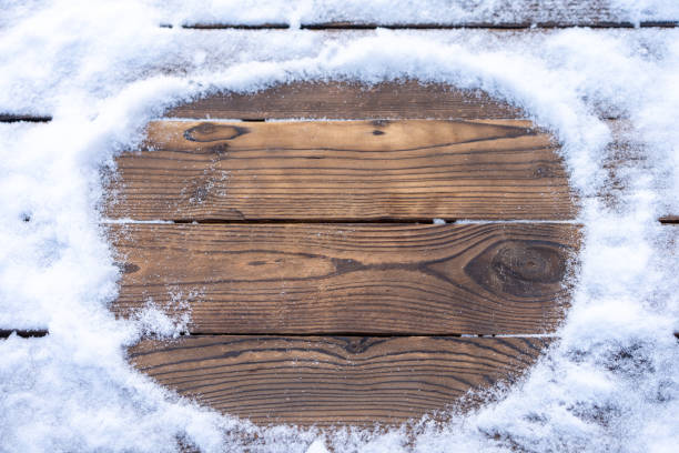 istock Winter background. Empty wooden plank with snow border, copy space for text 1343234205
