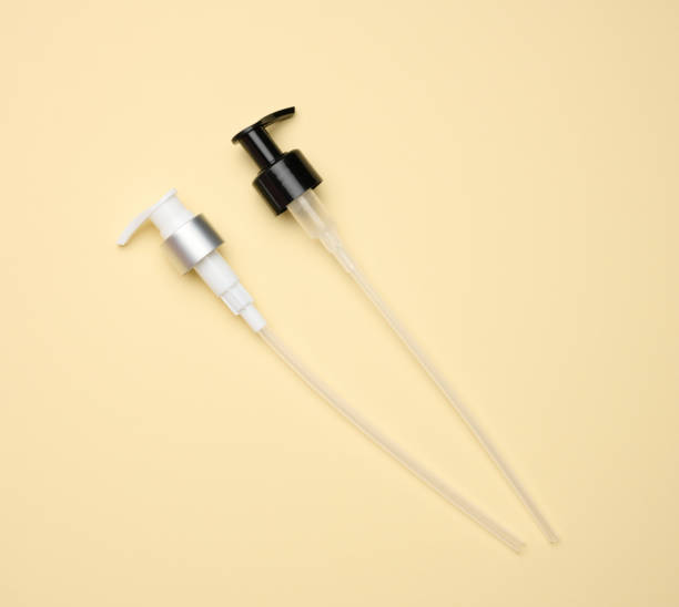istock plastic dispenser with a straw for glass and plastic bottles with liquid on a light yellow background 1343237001