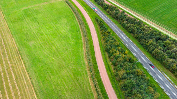 istock Road through rural scene - aerial view 1343238805