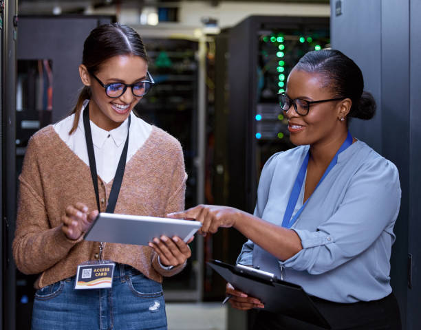 istock Cropped shot of two attractive young female computer programmers working together in a server room 1343240494