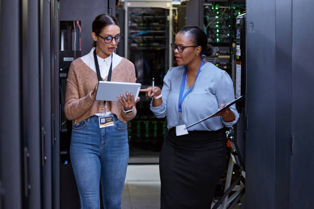 istock Cropped shot of two attractive young female computer programmers working together in a server room 1343240859