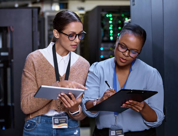 istock Cropped shot of two attractive young female computer programmers working together in a server room 1343240864