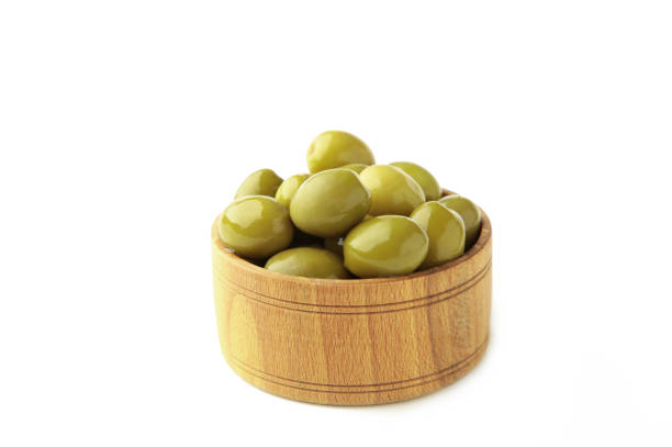 istock Isolated wooden bowl with green tinned olives 1343245355