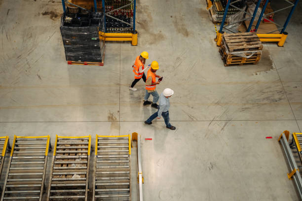 istock Warehouse employees walking through shelves having meeting 1343262231