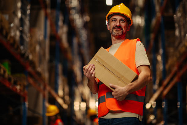 istock Worker carrying cardboard box at warehouse 1343262250