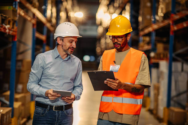 istock Supervisor and male worker at meeting in warehouse 1343262256