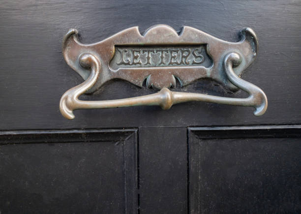 istock Antique brass letter box and door knocker 1343262308