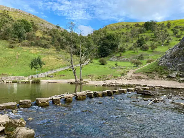 The stepping stones in the river Dove at Dovedale in the Peak District National Park in Derbyshire, UK