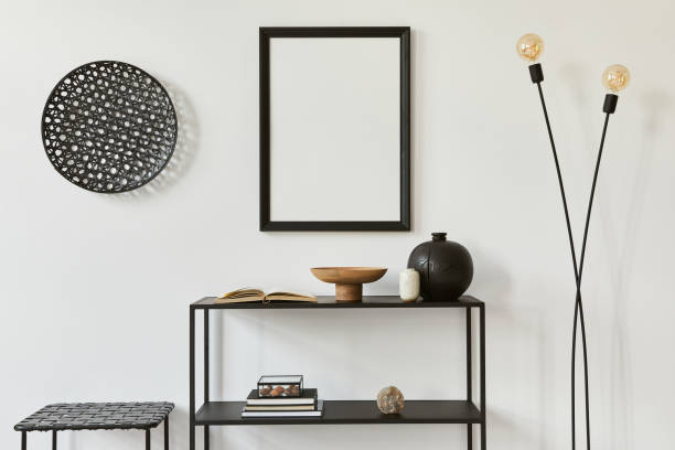 istock Minimalistic stylish composition of creative room interior design with mock up poster frame, metal shelf, plants and personal accessories. Black and white concept. Template. 1343263358