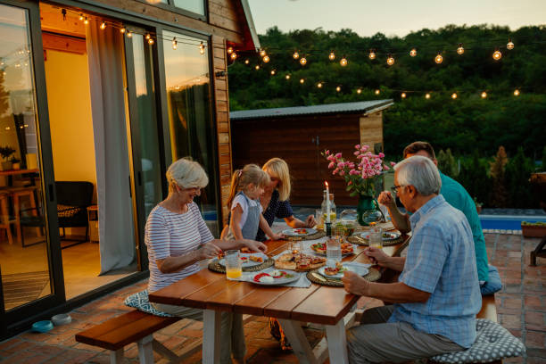 istock Multi-generation family having dinner outdoors in the backyard 1343265501