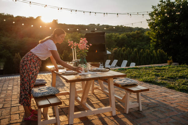 istock Attractive woman setting a table for the dinner in the backyard 1343265560